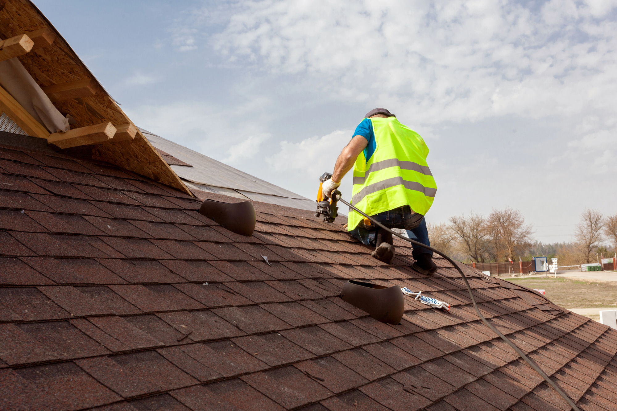 Roofer inspecting a pitched tiled roof – roof defects identified during a building survey